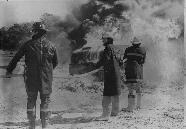 From the Archives.  Training in 1972.  From The Westerly Sun 10/16/72.  Caption reads: &quot;Firemen from the Southern League completed the observance of Fire Prevention Week yesterday with a live training program in the Romanella gravel bank at Dunn's Corners.  Here some of the firemen are shown dousing an oil fire with a new product known as Aer-O-Water3.  Between 800 and 1000 gallons of high octane fuel were used in the blaze.  Chief Fred Stanley of the Hope Valley Fire Department was in charge of the program and termed it very successful.  About 100 firemen participated.&quot;